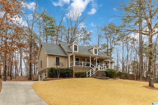 cape cod home with a garage, covered porch, and a front yard