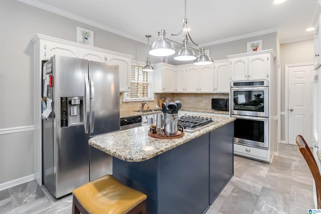 kitchen featuring white cabinetry, appliances with stainless steel finishes, decorative light fixtures, and a kitchen island