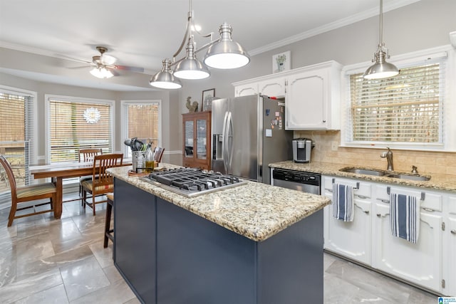 kitchen with sink, decorative light fixtures, a center island, appliances with stainless steel finishes, and white cabinets