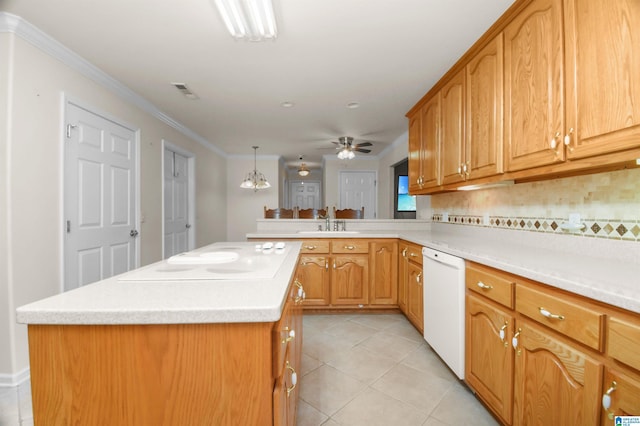 kitchen with a kitchen island, sink, decorative backsplash, hanging light fixtures, and white appliances