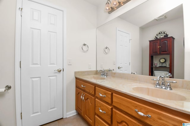 bathroom featuring vanity, toilet, and tile patterned flooring