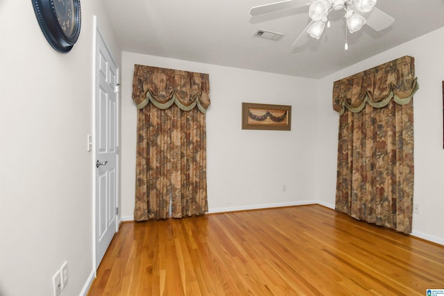 unfurnished room with hardwood / wood-style floors and ceiling fan