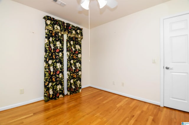 spare room featuring ceiling fan and hardwood / wood-style floors