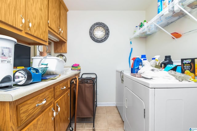 washroom featuring washing machine and clothes dryer and light tile patterned floors