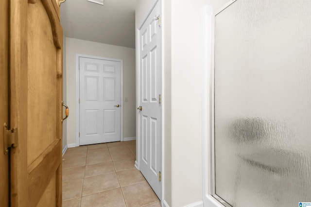 corridor with light tile patterned floors