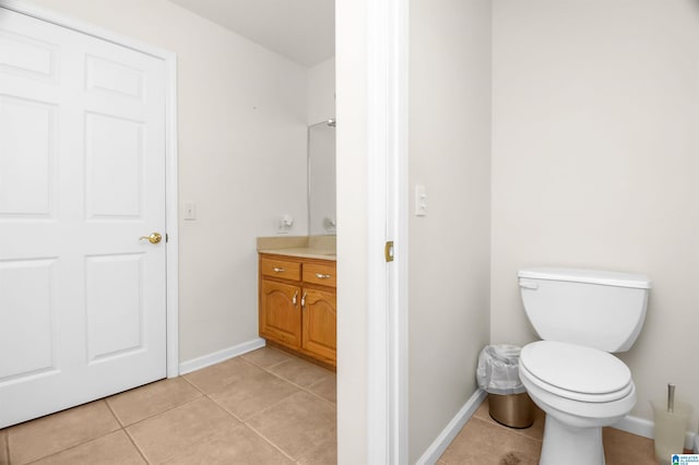 bathroom with vanity, tile patterned floors, and toilet