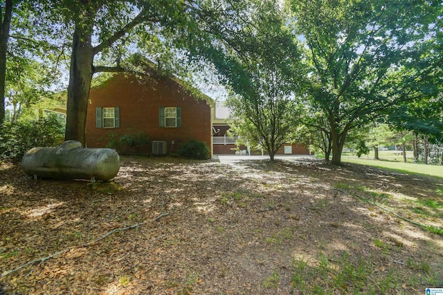 view of side of home with central AC