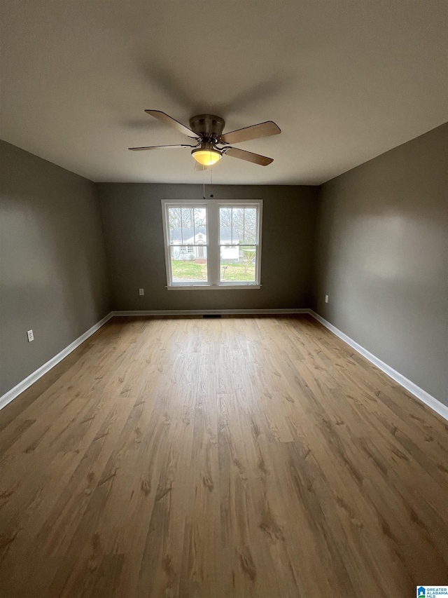 spare room with light hardwood / wood-style floors and ceiling fan