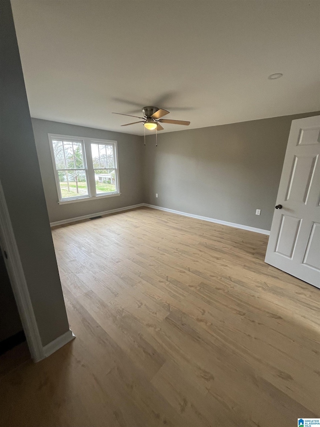 unfurnished room featuring ceiling fan and light hardwood / wood-style flooring