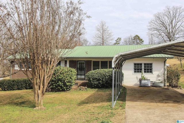 ranch-style home with a carport and a front lawn