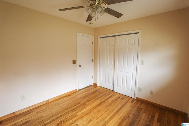 unfurnished bedroom featuring ceiling fan, wood-type flooring, and a closet