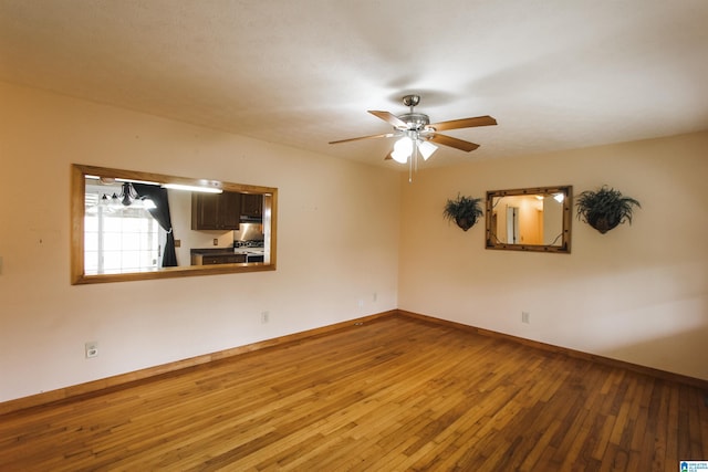 empty room with hardwood / wood-style flooring and ceiling fan