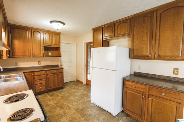 kitchen featuring white appliances and sink