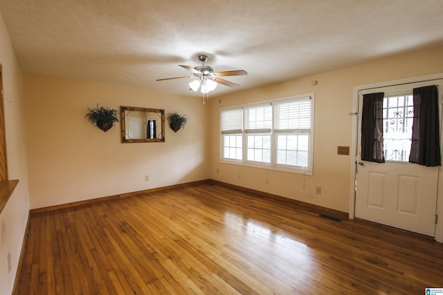 entrance foyer featuring ceiling fan and wood-type flooring