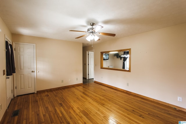 unfurnished room featuring hardwood / wood-style floors and ceiling fan