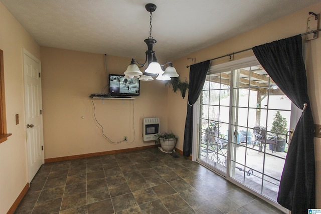 unfurnished dining area featuring heating unit and a notable chandelier