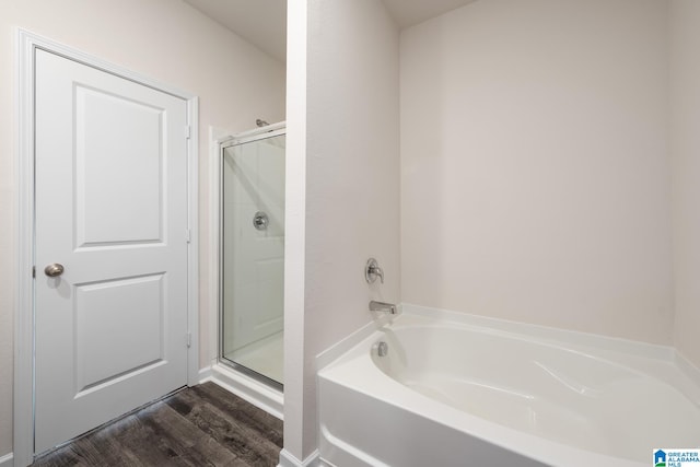 bathroom with separate shower and tub and hardwood / wood-style floors