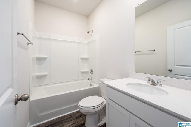 full bathroom featuring vanity, tub / shower combination, hardwood / wood-style floors, and toilet