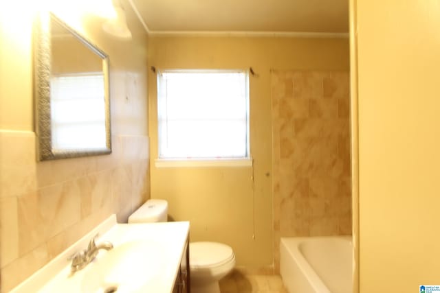 bathroom featuring vanity, tile walls, and toilet