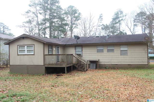 back of house with a deck and a lawn