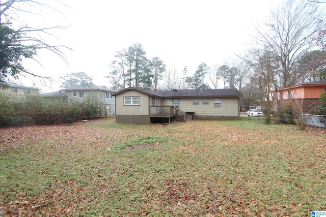 rear view of property featuring a yard