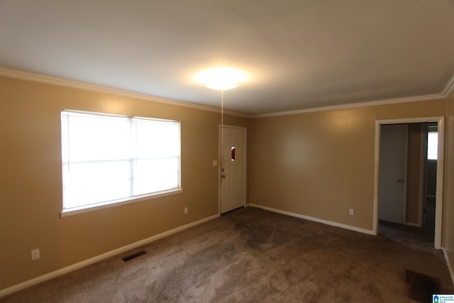 unfurnished room with crown molding and dark carpet