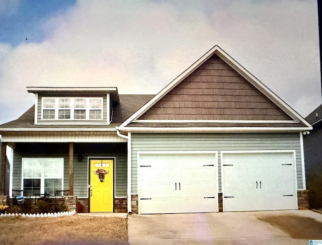 craftsman inspired home with a porch and a garage