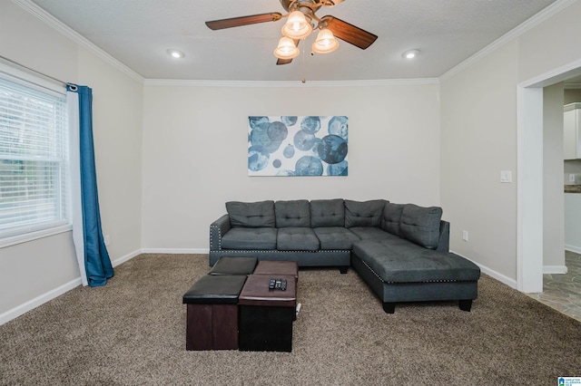 living room featuring crown molding, carpet, a textured ceiling, and ceiling fan