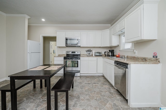 kitchen featuring sink, white cabinets, stainless steel appliances, crown molding, and light stone countertops