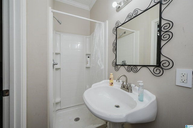 bathroom with walk in shower, ornamental molding, and sink