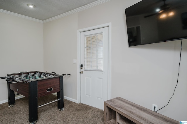 game room featuring ornamental molding, carpet flooring, and a textured ceiling