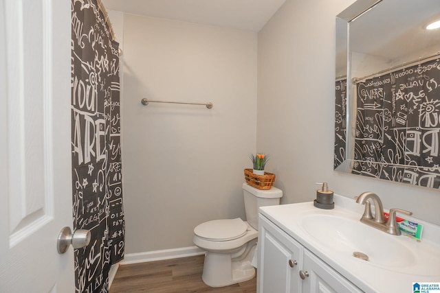 bathroom featuring hardwood / wood-style flooring, vanity, and toilet