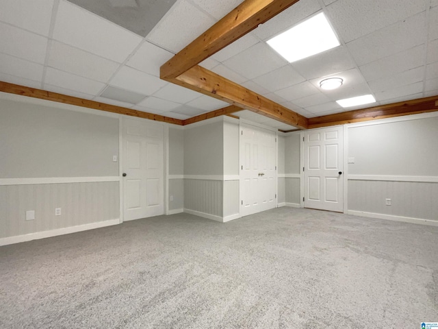 basement with a drop ceiling and carpet floors