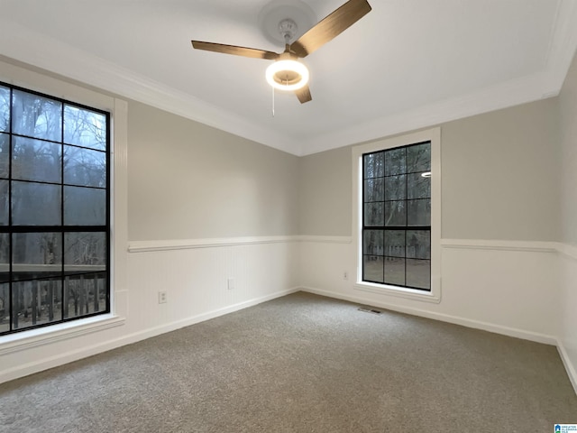 empty room with crown molding, carpet floors, and ceiling fan