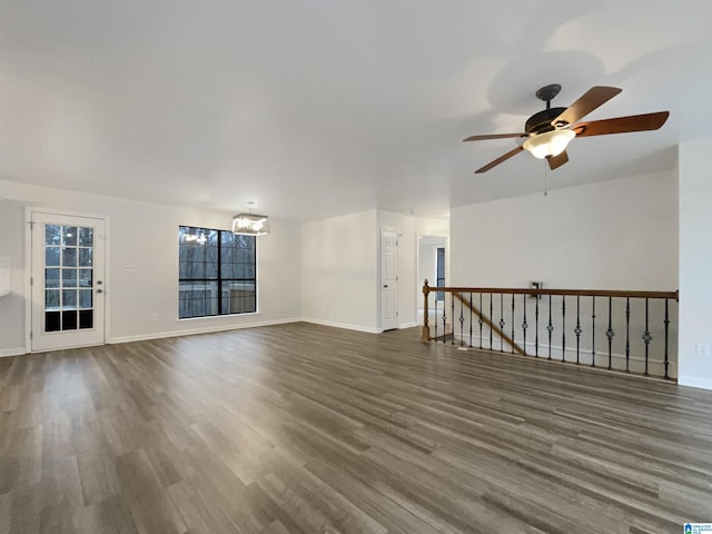 unfurnished living room featuring dark hardwood / wood-style floors and ceiling fan