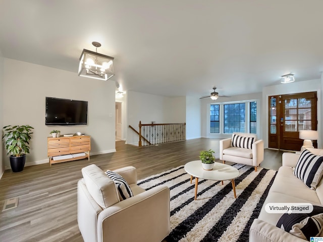 living room featuring hardwood / wood-style flooring and a chandelier