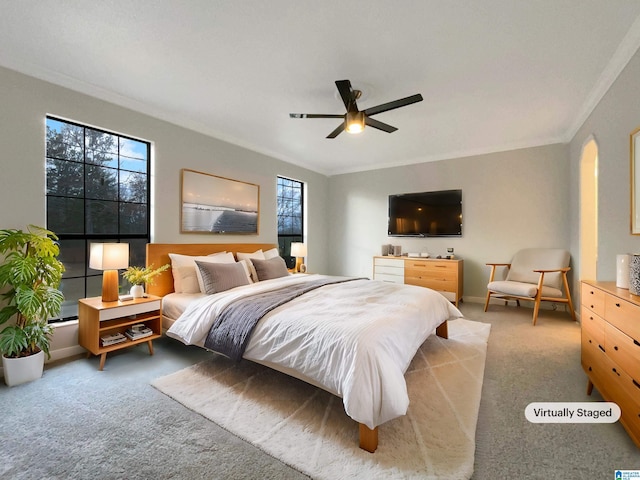 bedroom with ceiling fan, ornamental molding, and light carpet