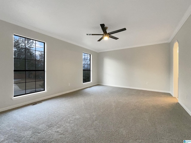 carpeted spare room with crown molding and ceiling fan