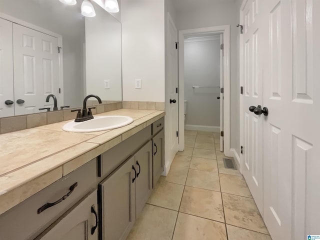 bathroom with vanity and tile patterned floors