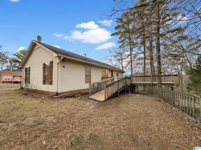 back of house featuring a wooden deck