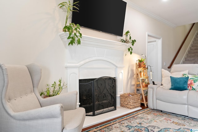 living room with crown molding and hardwood / wood-style flooring