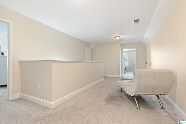 sitting room featuring light carpet