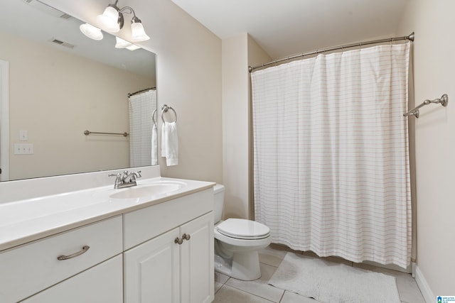 bathroom with vanity, tile patterned floors, and toilet