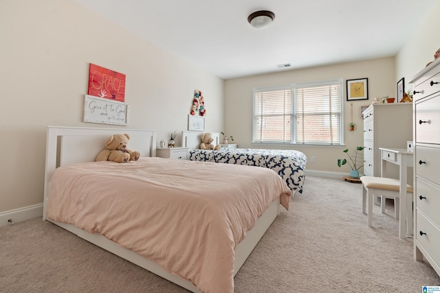 bedroom featuring light carpet