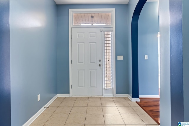 entryway with light tile patterned flooring