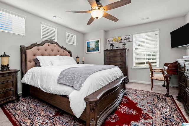 bedroom featuring ceiling fan and dark colored carpet