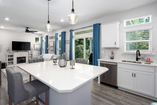 121 Palmer Cv, Birmingham, AL 35242 - kitchen with stainless steel dishwasher, a kitchen bar, white cabinets, pendant lighting, and light countertops