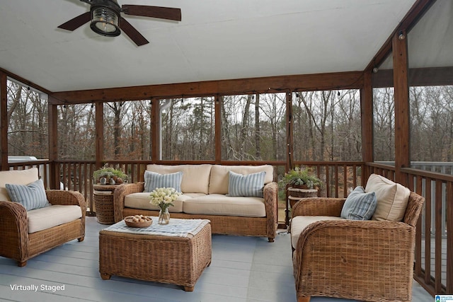 sunroom / solarium with ceiling fan and vaulted ceiling