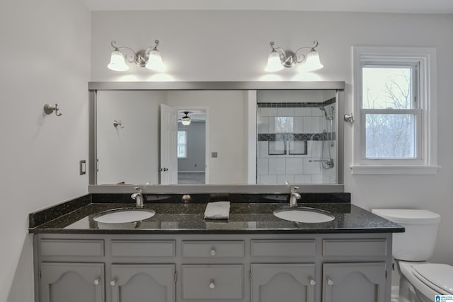 bathroom featuring ceiling fan, vanity, and toilet