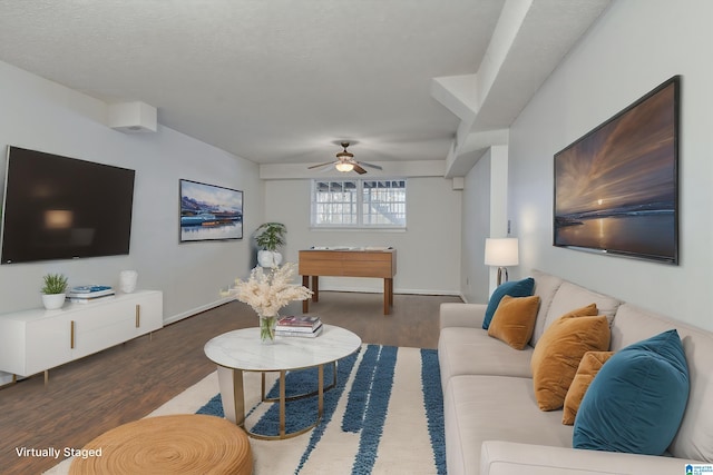 living room with dark wood-type flooring, a textured ceiling, and ceiling fan